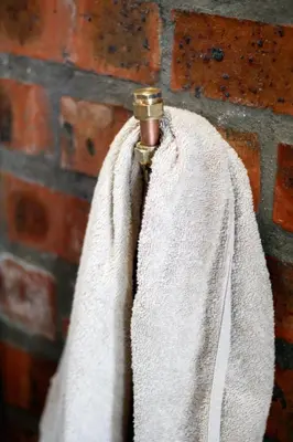 a towel hanging on a brick wall at Rustic Retreat Apartment in Durbanville in Durbanville
