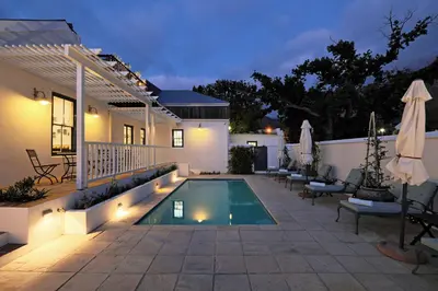 a backyard with a swimming pool and a house at Chapter House Boutique Hotel by The Living Journey Collection in Franschhoek