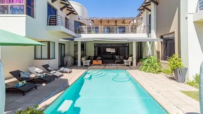 a swimming pool in the backyard of a house at Atlantic Waves Guest House in Cape Town