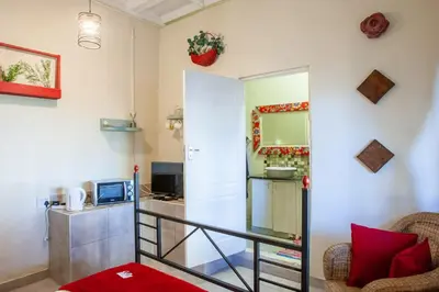 a room with a staircase and a living room at Bedrock Guest Studios in Strand