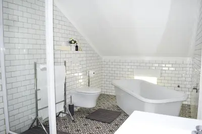 a white bathroom with a toilet and a sink at Knorhoek Country Guesthouse in Stellenbosch