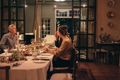 a group of people sitting at a dinner table at La Clé Lodge in Franschhoek