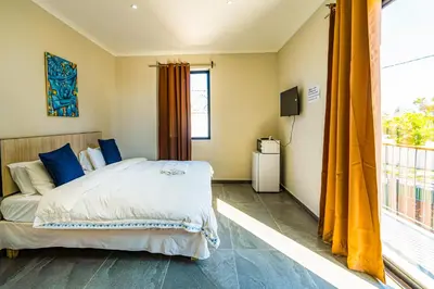 a bedroom with a bed and a large window at Cape Town Milnerton Lagoon Villa in Cape Town