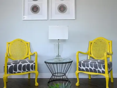 two yellow chairs with a table in a room at Atlantic Oasis Guest House in Table View