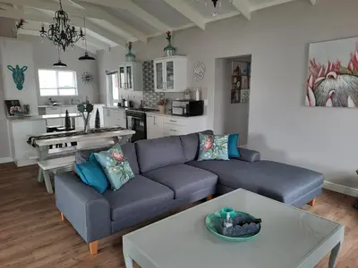 a living room with a couch and a table at Heavenly Breeze in Hermanus