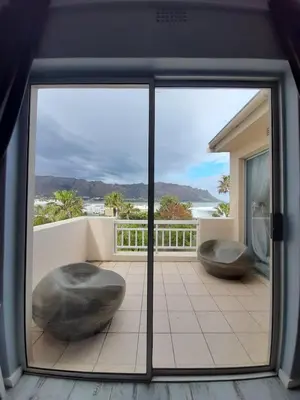 a view of a balcony with two large rocks at Nagua bay in Gordonʼs Bay