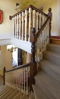a staircase in a home with wooden railings at Brooklands House in Cape Town