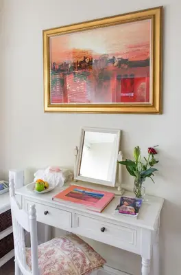 a white desk with a mirror and a picture on the wall at Brooklands House in Cape Town