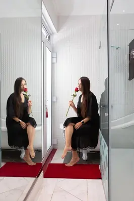 a woman sitting in a chair in front of a mirror at Adrian D'Cap Boutique Manor in Stellenbosch