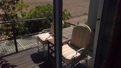 two chairs sitting on the porch of a house at Little Farm in Raithby