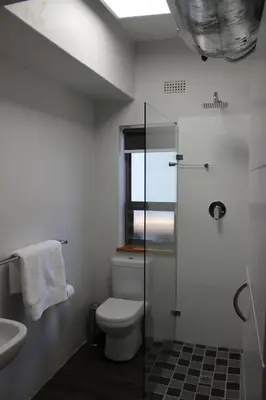 a bathroom with a toilet and a sink at Zeederberg Corner in Paarl