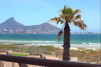 a palm tree sitting on top of a beach at Neptune Isle 214 in Cape Town