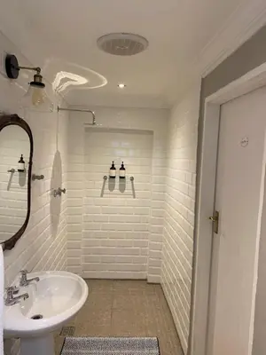 a white bathroom with a sink and a mirror at Mount Grace Country House in Greyton