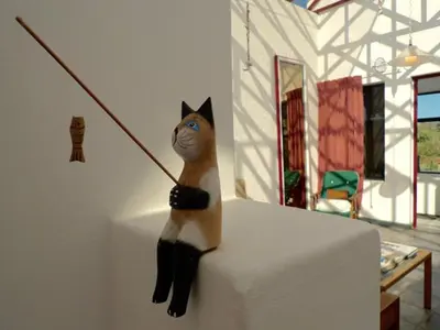 a toy cat sitting on top of a table at Sky house on Clarens in Bettyʼs Bay