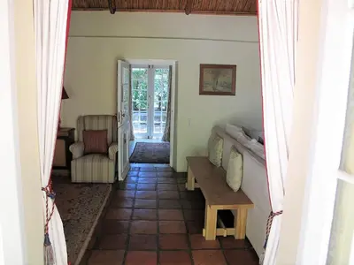 a living room with a table and a couch at High Hopes in Greyton