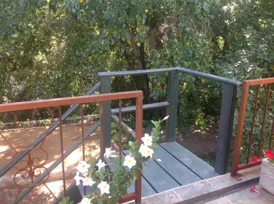 a blue gate with a plant on the side of it at Willow Brooke Guest Suite in Franschhoek