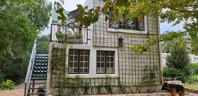 a house with a dog standing in front of it at Willow Brooke Guest Suite in Franschhoek