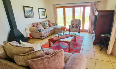 a living room with a couch and a coffee table at Mountainview Vineyards in Robertson