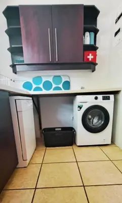 a kitchen with a washing machine under a counter at Mountainview Vineyards in Robertson