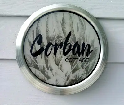a sign on a door with the word cambrian coffee at Corban Cottage in Hermanus