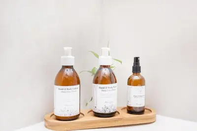 three bottles of moisturizers sitting on a wooden shelf at 10VDW Self Catering Apartments-Newly Renovated! in Durbanville