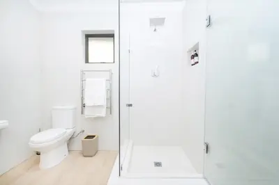 a white bathroom with a toilet and a shower at 10VDW Self Catering Apartments-Newly Renovated! in Durbanville