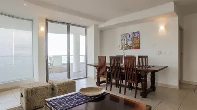 a living room with a dining room table and chairs at Hibernian Towers 505 in Strand
