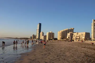 a group of people on a beach with buildings at Hibernian Towers 505 in Strand