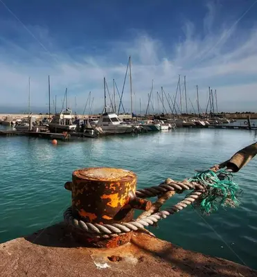 a rope tied to a dock with boats in the water at 20 Cayman Beach, Gordon's Bay in Gordonʼs Bay