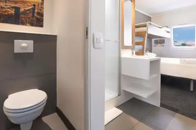 a bathroom with a toilet and a sink at SUN1 MILNERTON in Cape Town