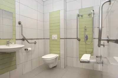 a bathroom with a toilet and a sink and a shower at SUN1 MILNERTON in Cape Town