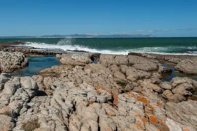 a rocky shore with waves crashing on the ocean at 63 Whalerock Estate in Hermanus