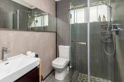 a bathroom with a shower and a toilet and a sink at 63 Whalerock Estate in Hermanus
