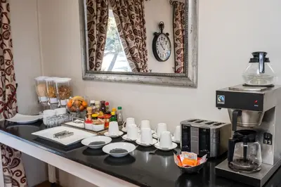 a kitchen counter with a coffee maker and a coffee machine at Plattekloof Premium Lodge in Plattekloof