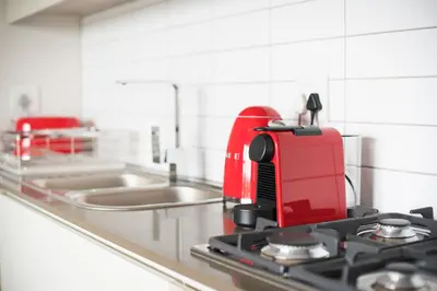 a red appliance sitting on top of a kitchen counter at Waters Edge Self-Catering Apartment in Cape Town