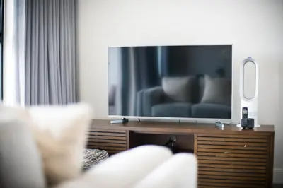 a living room with a large flat screen tv at Waters Edge Self-Catering Apartment in Cape Town