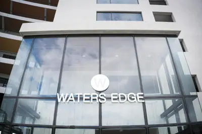 a waterer edge sign on a building at Waters Edge Self-Catering Apartment in Cape Town