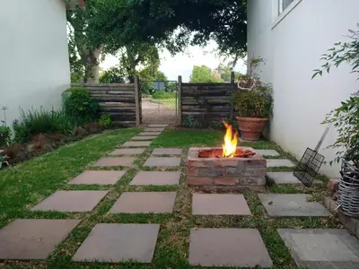 a fire pit in the backyard of a house at Olive and Vine Farm Cottage in Franschhoek