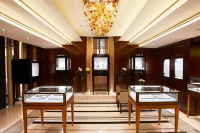 a lobby with two tables and a chandelier at Delaire Graff Lodges and Spa in Stellenbosch
