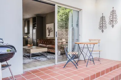 a living room with a couch and a table at Avemore Vredehof No 3 full back up power in Stellenbosch