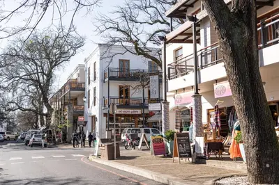 a busy city street with buildings and cars on the road at Avemore Jan Cats No 2 full power back up in Stellenbosch