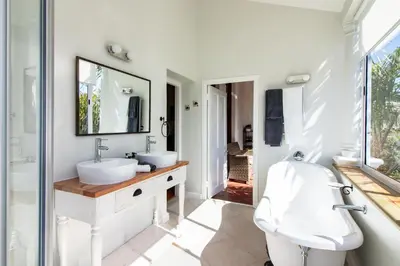 a bathroom with two sinks and a mirror at Carmichael House Boutique Hotel in Cape Town