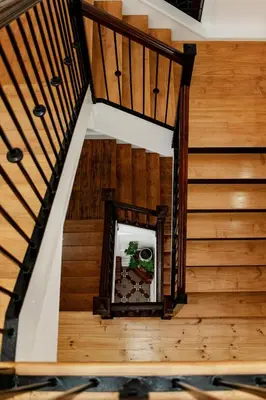 a staircase in a house with wooden floors and a mirror at Carmichael House Boutique Hotel in Cape Town