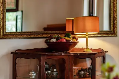 a bowl of fruit on a table in front of a mirror at Carmichael House Boutique Hotel in Cape Town