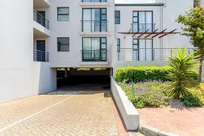 a white building with a courtyard in front of it at Waterstone A103 by CTHA in Cape Town