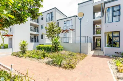 an apartment building with a pathway in front of it at Waterstone A103 by CTHA in Cape Town