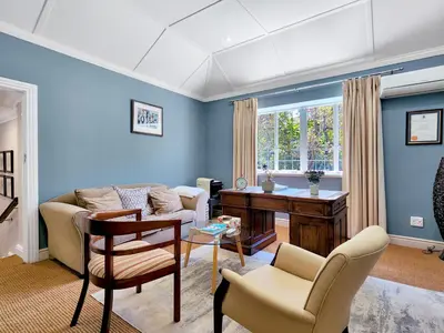 a living room with a couch and a table at Roodenburg House in Cape Town
