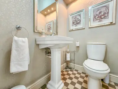 a bathroom with a white toilet and a sink at Roodenburg House in Cape Town