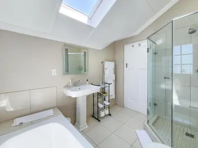 a bathroom with a sink and a shower at Roodenburg House in Cape Town