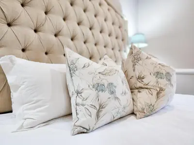 a group of pillows sitting on a bed at Roodenburg House in Cape Town